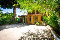 a driveway in front of a house with a fence at Pousada Por do Sol in Trancoso