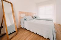Posteľ alebo postele v izbe v ubytovaní Apartamentos Rúa Vella