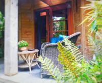 a wicker chair on the porch of a house at B&amp;B Aquavert &amp; Wellness in Tournai