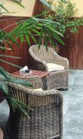 two wicker chairs and a table and a plant at B&amp;B Aquavert &amp; Wellness in Tournai