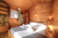 a bedroom with a bed in a wooden cabin at Chalet-Hôtel de l&#39;Etape in Les Contamines-Montjoie