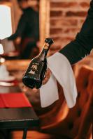 a person is holding a bottle of wine at Hotel & Restoran Dvorac Gjalski in Zabok