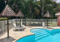 a swimming pool with chairs and a fence and a fence at DOUC IRMA in Les Trois-Îlets