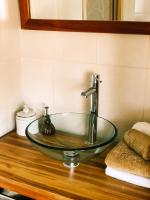 a bathroom sink with a glass bowl on a wooden counter at Maison d&#39;hôtes La Rose d&#39;Alsace in Rosheim