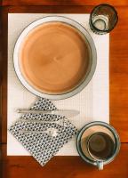 a cup of coffee sitting on a table with a plate at Maison d&#39;hôtes La Rose d&#39;Alsace in Rosheim