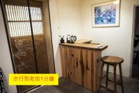 a wooden counter with a stool next to a door at Shabby Home 28 in Jiufen