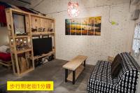 a living room with a tv and a table at Shabby Home 28 in Jiufen