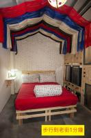 a bedroom with a large bed with a red blanket at Shabby Home 28 in Jiufen