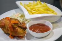 a plate of food with french fries and sauce at GreenPoint Hotel in Lagos