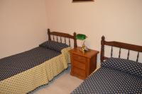 A bed or beds in a room at Casa Rural Consuelo
