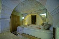 Postel nebo postele na pokoji v ubytování Cappa Cave Hotel
