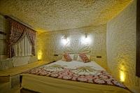 Postel nebo postele na pokoji v ubytování Cappa Cave Hotel