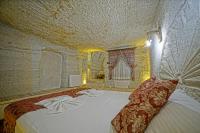 Postel nebo postele na pokoji v ubytování Cappa Cave Hotel