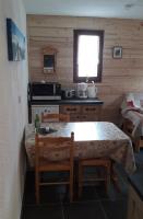 a kitchen with a table and two chairs and a table and a window at Appartement 4 pers Saint Gervais les Bains in Saint-Gervais-les-Bains