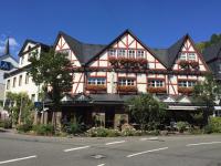 Un gran edificio rojo y blanco al costado de una calle. en Hotel Garni Maaß, en Braubach