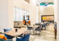 a dining room with tables and chairs at Holiday Inn Express Kolkata Airport by IHG in Kolkata