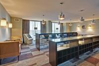 a bar in a hotel room with chairs and tables at Crowne Plaza Chicago O'Hare Hotel & Conference Center by IHG in Rosemont