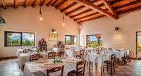 a banquet hall with white tables and chairs and windows at Agriturismo Borgo degli ulivi in Canicattini Bagni