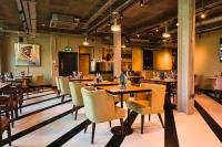 a restaurant with tables and chairs in a room at The Chamberlain in London