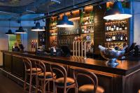 a bar with a bunch of chairs sitting at it at The Chamberlain in London