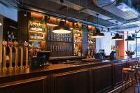 a bar with a counter and some lights at The Chamberlain in London