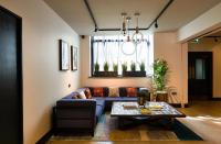 a living room with a blue couch and a table at The Chamberlain in London