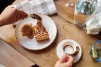 a person eating a piece of dessert on a table at The Chamberlain in London