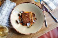 a plate of food on a table with nuts and bread at The Chamberlain in London