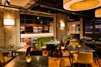 a restaurant with tables and chairs and a bar at The Chamberlain in London