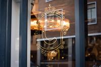 a window with a gold design on a glass door at The Chamberlain in London