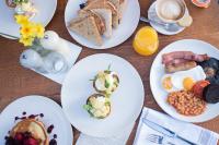 a table topped with plates of breakfast foods and coffee at The Chamberlain in London