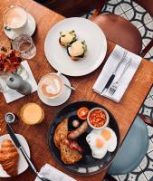a table with a plate of breakfast food on it at The Chamberlain in London