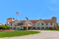 a building with two american flags in front of it at Eisenhower Hotel and Conference Center in Gettysburg