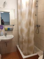 a bathroom with a shower curtain and a sink at Pension da Luigi in Greifswald