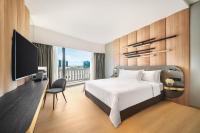 a bedroom with a bed and a flat screen tv at PARKROYAL COLLECTION Marina Bay, Singapore in Singapore