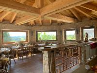 a restaurant with wooden ceilings and tables and windows at Hotel Alpenhof in Markneukirchen