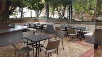 a patio with tables and chairs in a restaurant at Hotel das Palmeiras in Paracatu