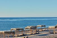 a group of straw umbrellas on the beach at Atlantica Dreams Resort in Gennadi