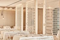 a dining room with white tables and white chairs at Atlantica Dreams Resort in Gennadi