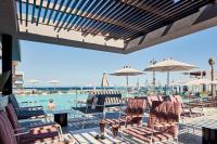a patio with chairs and tables and a pool at Atlantica Dreams Resort in Gennadi