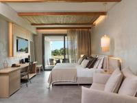 a bedroom with a bed and a living room at Atlantica Dreams Resort in Gennadi