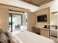 a hotel room with a bed and a television at Atlantica Dreams Resort in Gennadi