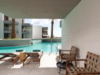 an outdoor patio with chairs and a swimming pool at Atlantica Dreams Resort in Gennadi