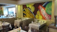 ein Restaurant mit zwei Tischen und einem Wandgemälde in der Unterkunft Hotel San Marcos Grand in Culiacán Rosales