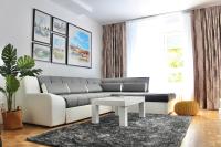 a living room with a couch and a table at Ramonda Residences - New Belgrade in Belgrade