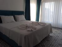 A bed or beds in a room at ada kekiği pansiyon