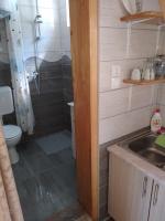 a bathroom with a shower and a sink and a toilet at Vikendica pored Drine Foča in Handići