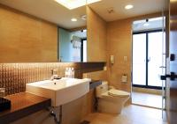 a bathroom with a sink and a toilet and a mirror at Yang Ming Shan Tien Lai Resort &amp; Spa in Jinshan