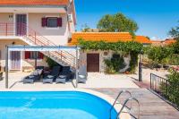 a villa with a swimming pool and a house at Holiday Home Rosko in Skradin