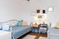 a bedroom with two beds and a table with a tv at Holiday Home Rosko in Skradin